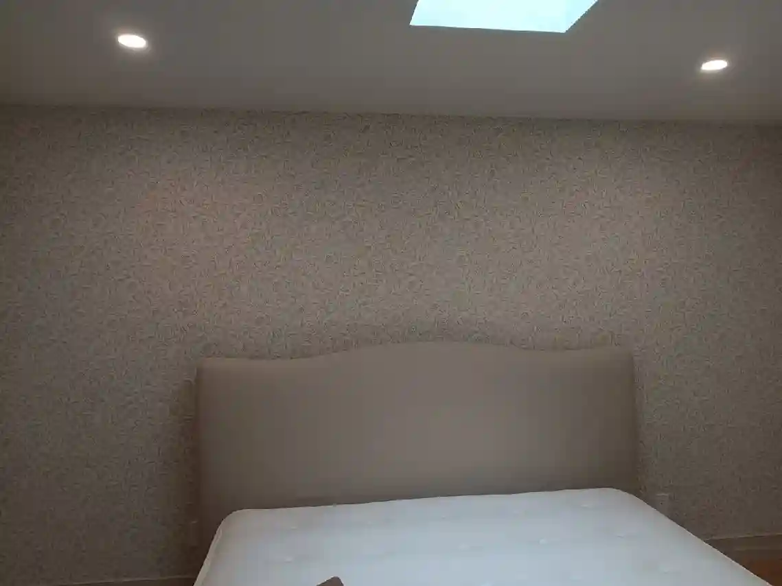 Residential wallpaper installer working in a Portland home